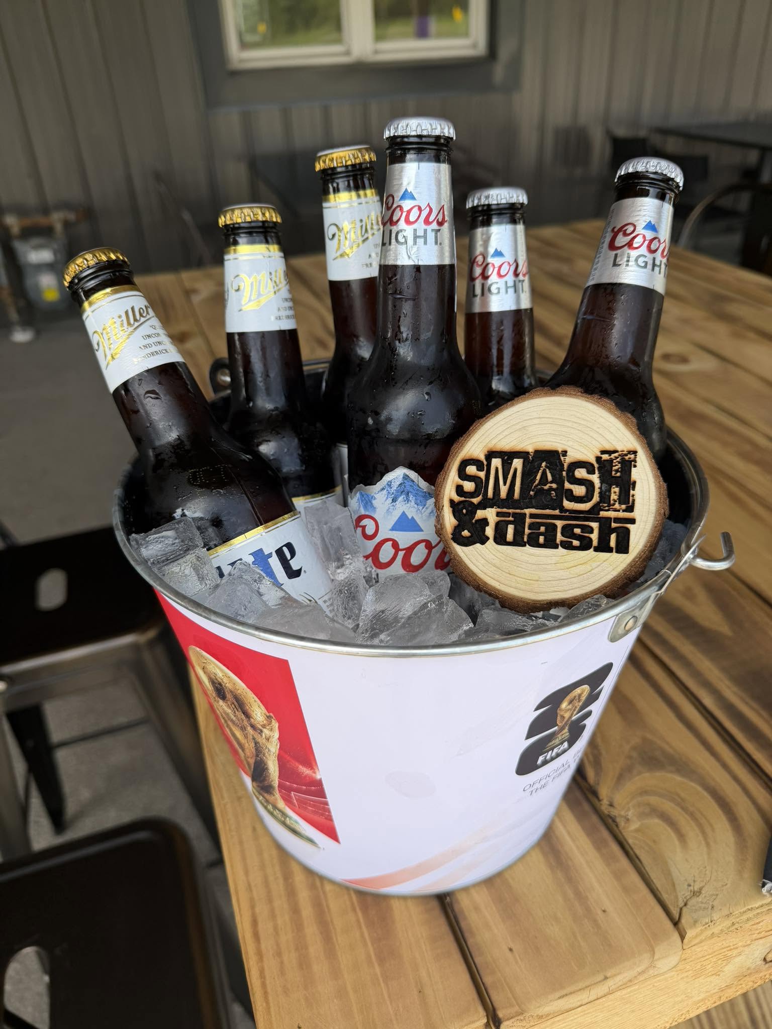 A bucket of cold bottles on the table